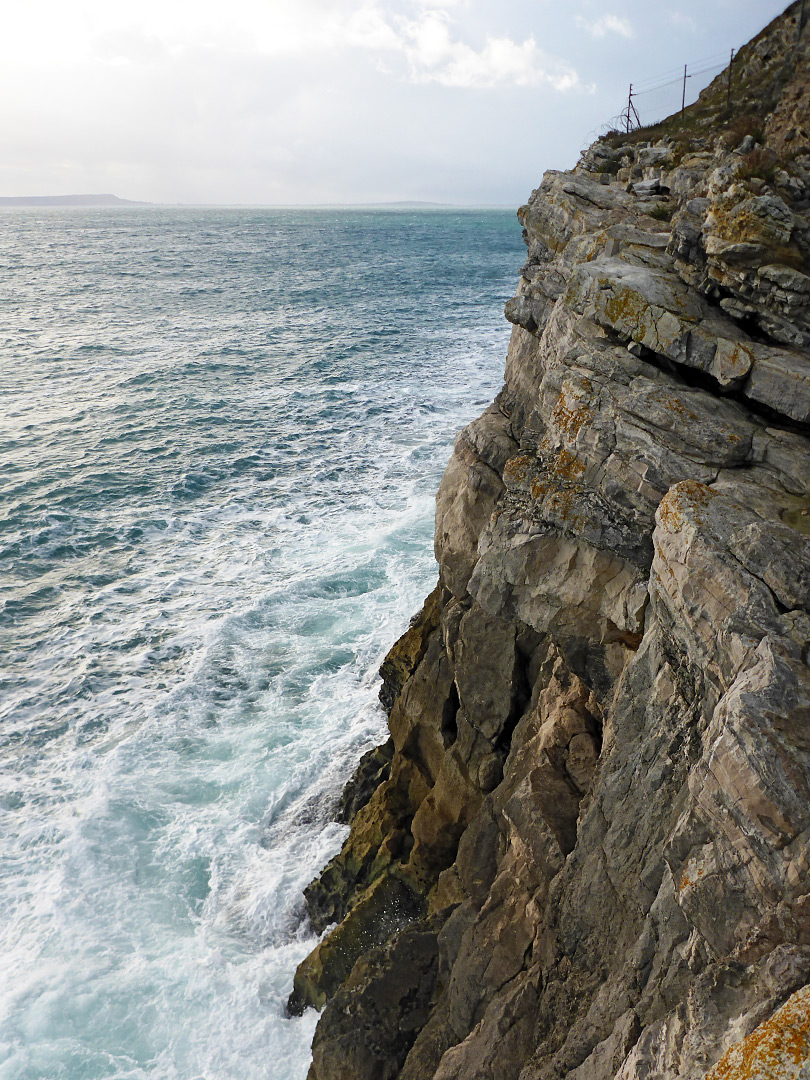 Waves below a cliff