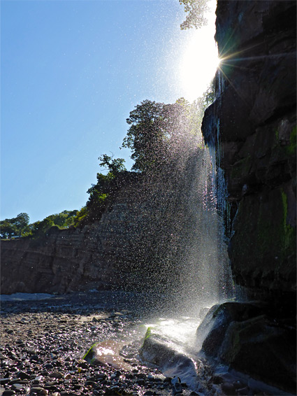 Spray from the waterfall at the west edge of St Audrie's Bay