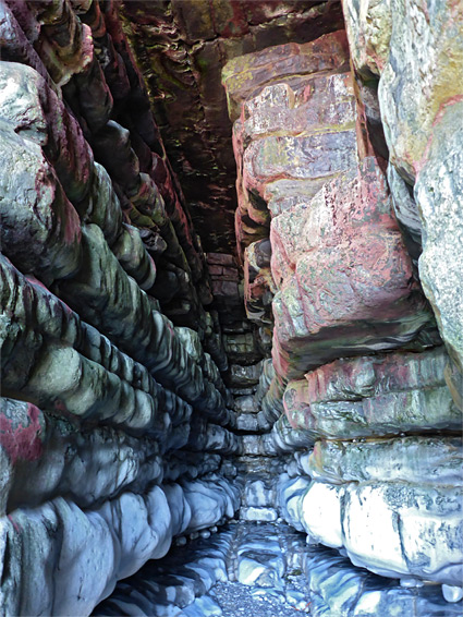 Reddish walls of a narrow sea cave